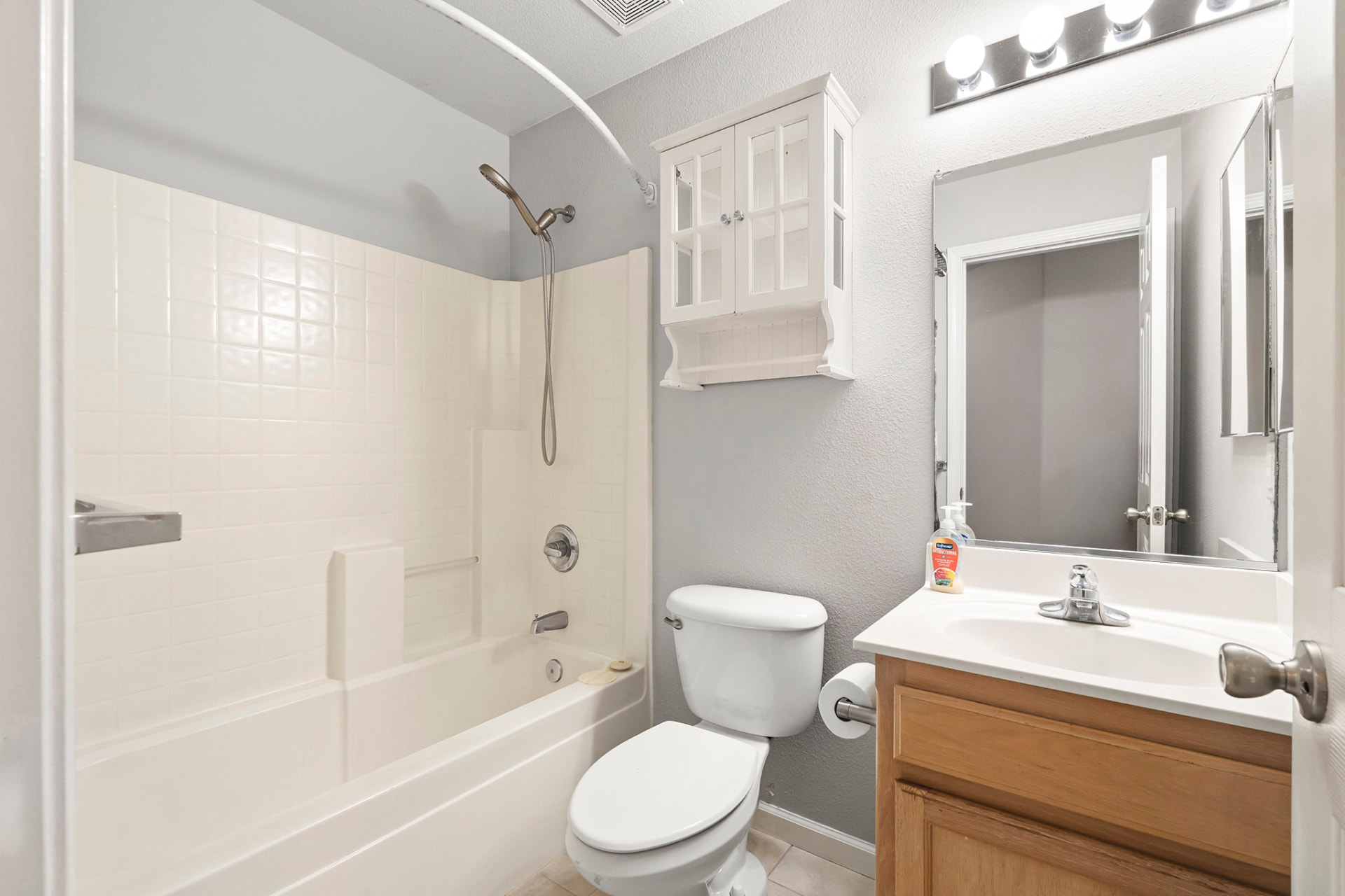 Hall bathroom with tub shower and vanity