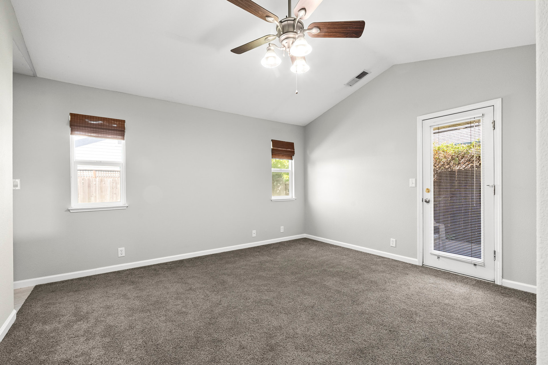 Primary bedroom with vaulted ceiling and private exterior door