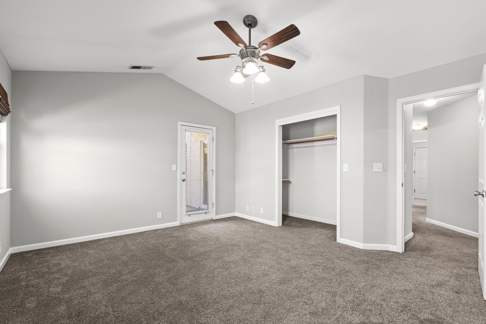 Primary bedroom with walk-in closet and private patio door