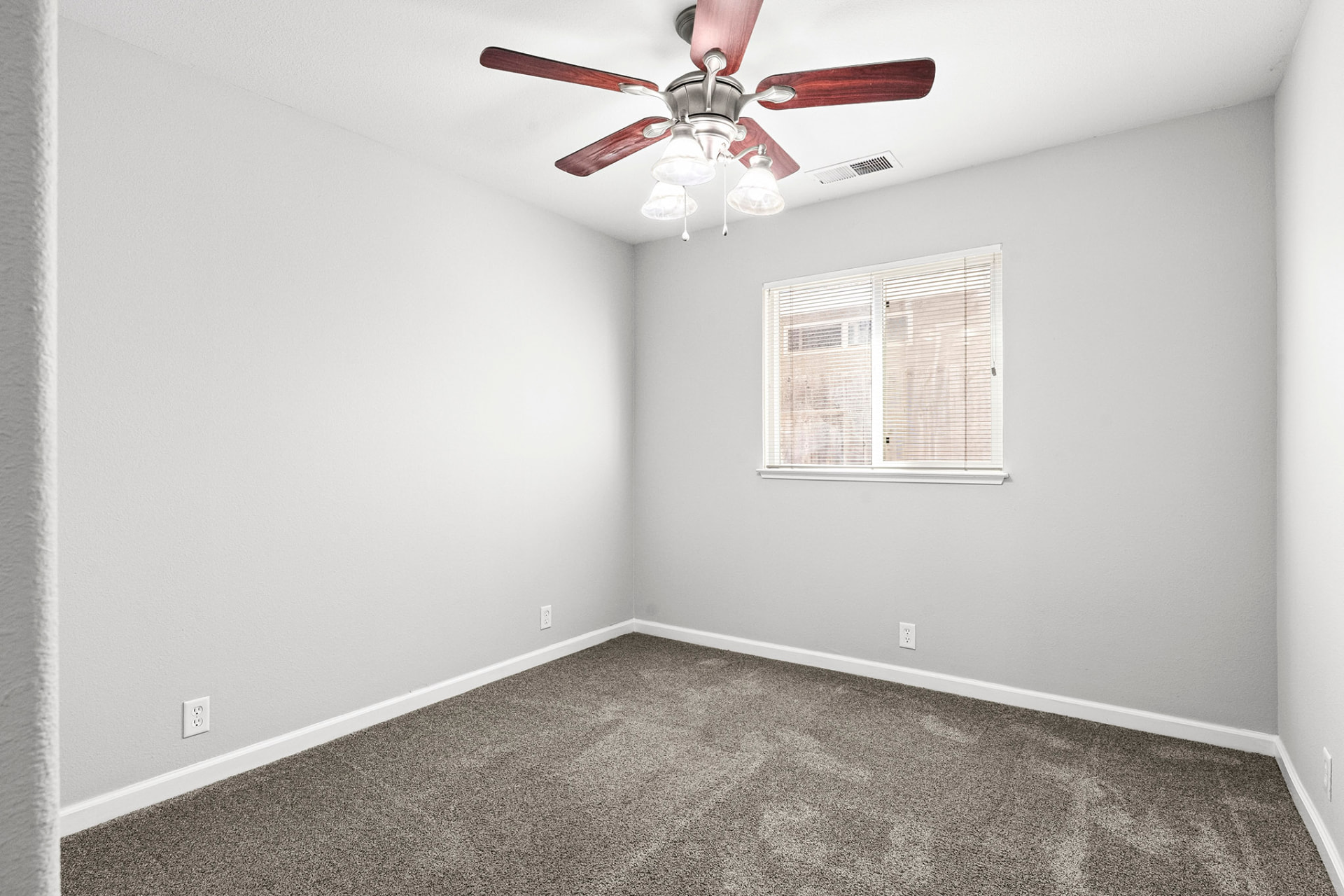 Bedroom with ceiling fan and window