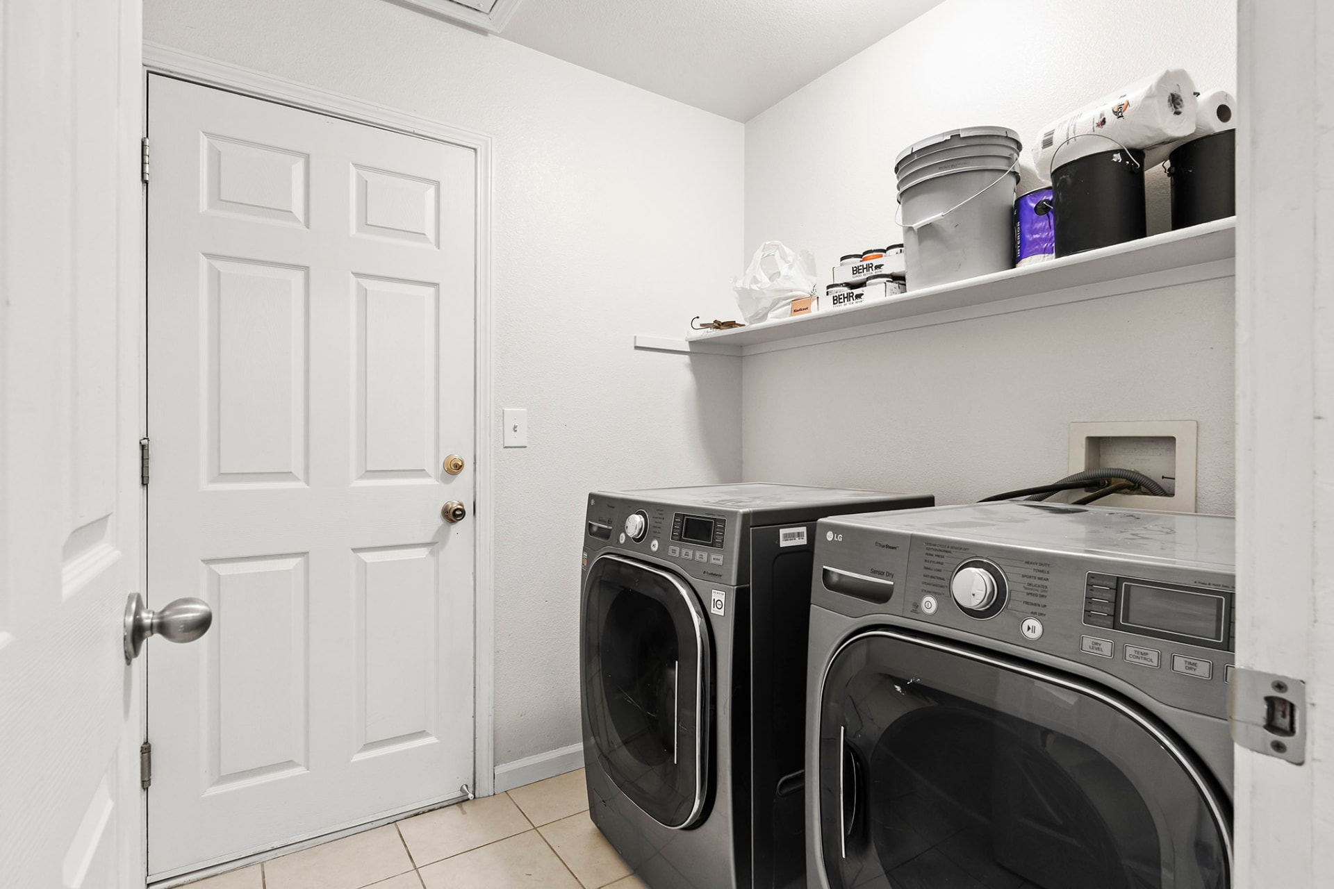 Indoor laundry room with side-by-side washer and dryer